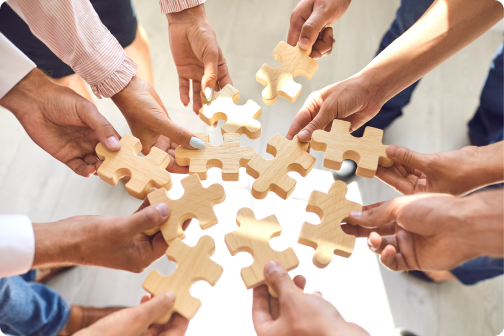 Peaople holding puzzle pieces